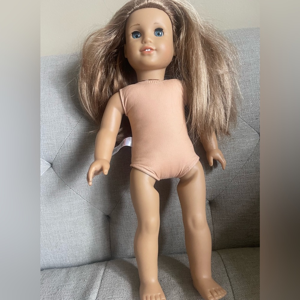 American Girl Doll with light brown hair and blue eyes